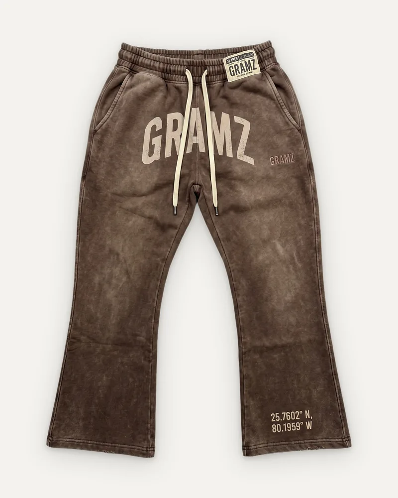 Design rendering: washed brown flared sweatpants with a sand arched GRAMZ print and Miami coordinates at the hem